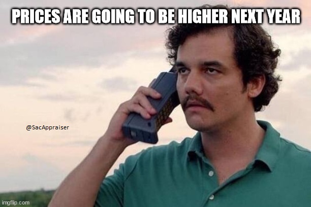Pablo Escobar on a cell phone from the 80s. It says, "prices are going to be higher next year." A meme.